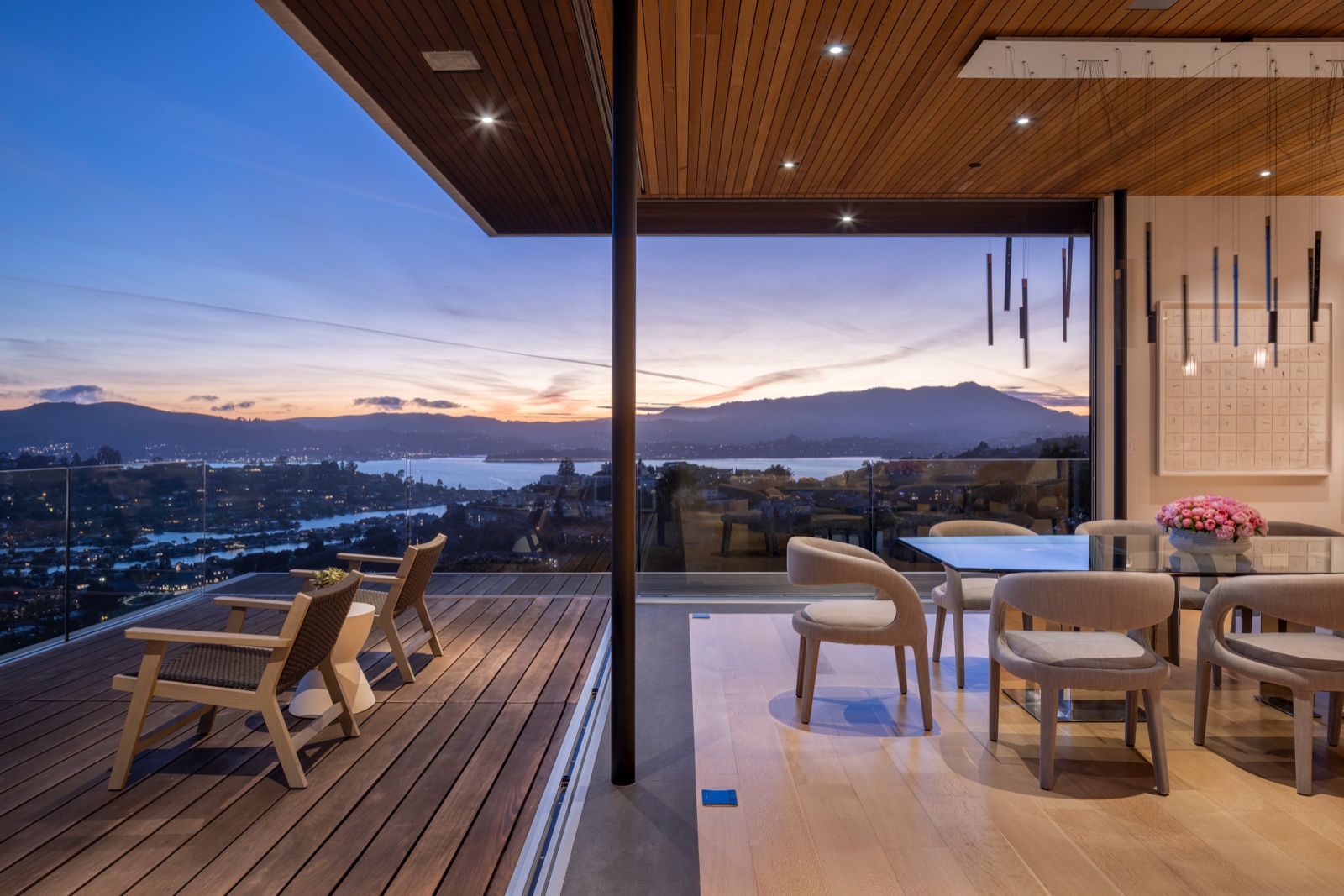 Dining opening through NanaWall glass at dusk
